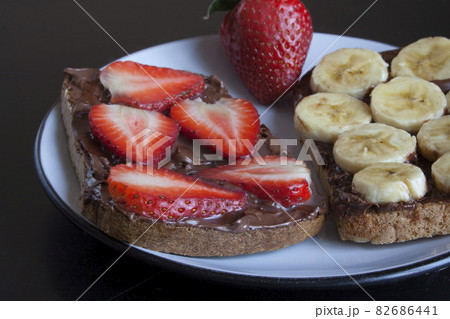 Two sweet sandwiches with banana and strawberries 82686441