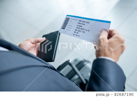 Male hands holding passport and plane ticket Male hands holding passport and plane ticket 82687190
