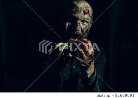 Zombie male makeup for halloween concept. Blood on skin face 82689691