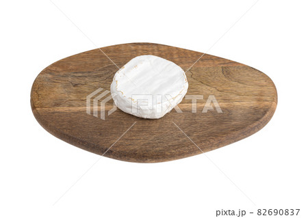 Camembert on a white background. Camembert cheese on a board close-up on a white background. Camembert on a white background. Camembert cheese on a board close-up on a white background. 82690837