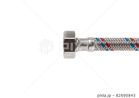 Flexible liner for water supply on a white background. Close-up of flexible metal braided hose. Flexible liner for water supply on a white background. Close-up of flexible metal braided hose. 82690843