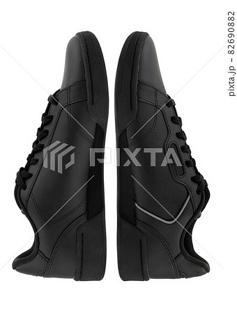 Sneakers isolated on white background. Black sneakers close-up on a white background. Sneakers isolated on white background. Black sneakers close-up on a white background. 82690882