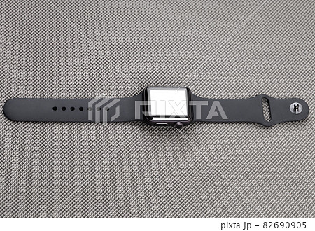 Smart watch with a blank white screen on a gray background. 82690905