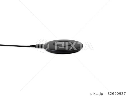 Wireless charging for a smartphone on a white background. Fast wireless charger close-up. Wireless charging for a smartphone on a white background. Fast wireless charger close-up. 82690927