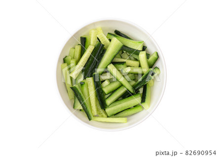 Sliced cucumber in a plate on a white background. Fresh cucumber sliced into pieces close-up. Sliced cucumber in a plate on a white background. Fresh cucumber sliced into pieces close-up. 82690954