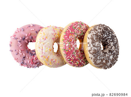 Donuts close-up on a white background. Round donuts isolated on white background. Donuts close-up on a white background. Round donuts isolated on white background. 82690984