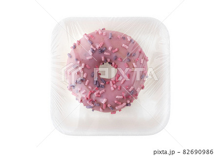 Donut close-up on a white background. Round donut in packaging close-up. Donut close-up on a white background. Round donut in packaging close-up. 82690986