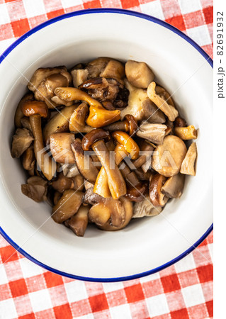 Sliced preserved mushrooms in bowl. Sliced preserved mushrooms in bowl. 82691932