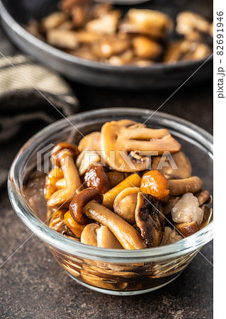 Sliced preserved mushrooms in bowl. 82691946