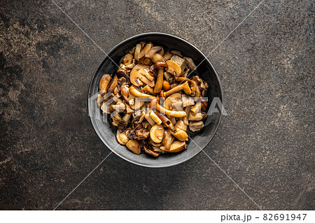 Sliced preserved mushrooms in bowl. 82691947