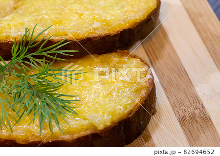 Hot sandwiches with melted cheese and herbs on wooden background Hot sandwiches with melted cheese and herbs on wooden background 82694652
