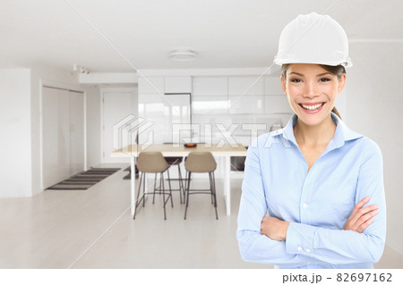 Home architect business woman house inspection of new condo project building inspecting remodeled modern kitchen. Happy Asian architect professional with hard hat helmet 82697162