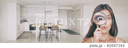 Home inspection funny woman searching through magnifying glass looking at kitchen for hidden vice real estate new homeowner buyer inspecting for mold, water damage, crack. Panoramic banner 82697163