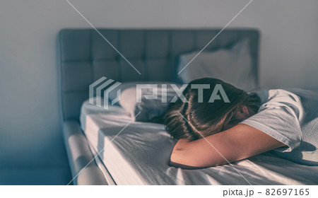Home quarantine self isolation woman tired bored cant get up of bed staying asleep late sleepiness sleep disorder. Sad girl crying alone 82697165
