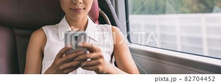 Bus travel commute young woman holding mobile phone texting using 5g technology device panoramic banner background. Businesspeople lifestyle. Closeup of hands on cellphone 82704452