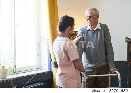 Senior Man Using Walker in Nursing Home Senior Man Using Walker in Nursing Home 82704680