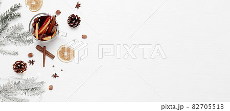 Christmas banner flat lay with glass cup of Mulled Wine, gift box, decorations 82705513