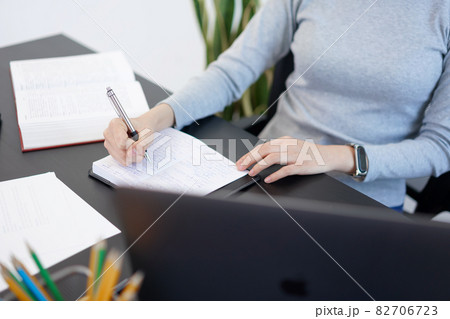 Office work concept a female secretary writing and taking notes for what she listening about important business information 82706723