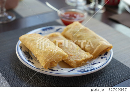 Traditional spring rolls on white plate 82709347