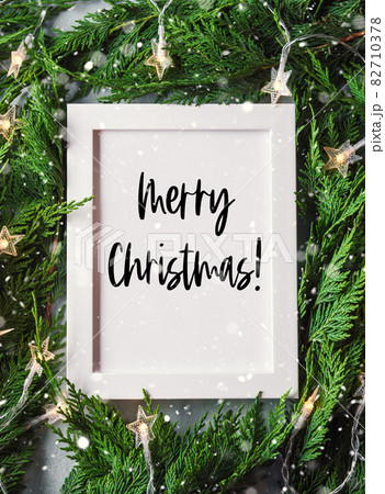 Green branches with star shape lights, frame wishing Merry Christmas Green branches with star shape lights, frame wishing Merry Christmas 82710378