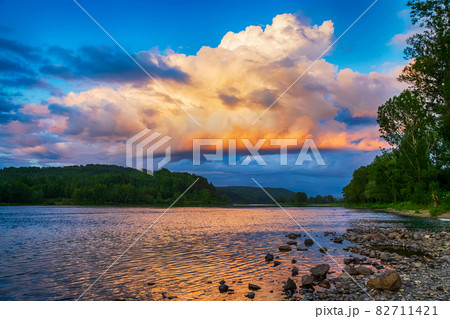 Summer river landscape with sunset cloudy sky Summer river landscape with sunset cloudy sky 82711421