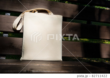 Canvas tote bag in the sunlight on the bench mockup 82711422