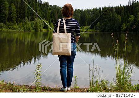 Woman in the striped long sleeve shirt carrying shopping bag mockup 82711427
