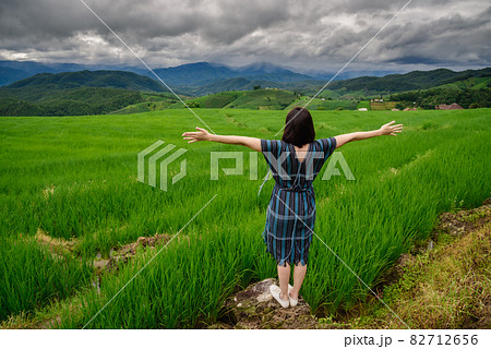 The scenery of a happy traveler standing in a terraced rice field at Mae Chaem, Chiang Mai, Thailand 82712656