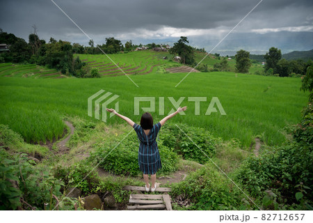 The scenery of a happy traveler standing in a terraced rice field at Mae Chaem, Chiang Mai, Thailand 82712657