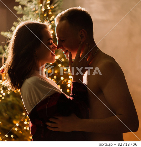 Love, christmas, couple, proposal concept - happy man giving diamond engagement ring to woman Love, christmas, couple, proposal concept - happy man giving diamond engagement ring to woman 82713706