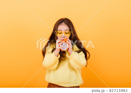 Cute little girl wearing bright stylish clothes on yellow colorful background Cute little girl wearing bright stylish clothes on yellow colorful background 82713962