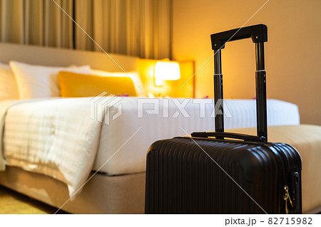 Suitcase and interior of hotel room 82715982