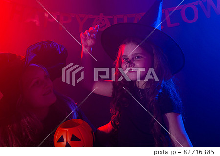 Funny child girl in witch costume for Halloween with spider. Funny child girl in witch costume for Halloween with spider. 82716385