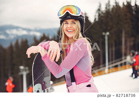 Girl snowboarding in the mountains with the snowboard Girl snowboarding in the mountains with the snowboard 82718736