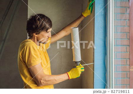 Builder or handyman is engaged in the repair or installation of windows 82719811