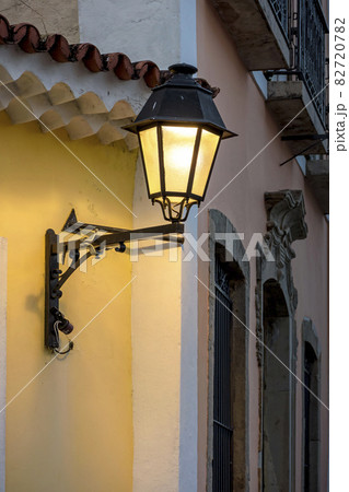 Old metal lanterns and colorful facade of a colonial house in the historic Pelourinho district 82720782