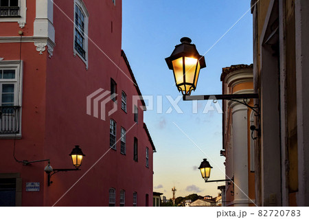 Old iluminated metal lanterns and facade of a colonial houses in the historic Pelourinho district 82720783