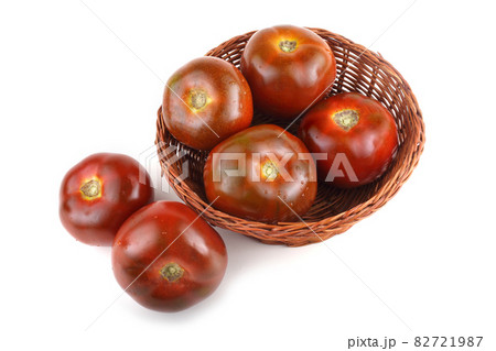 Brown tomatoes on wicker plate 82721987
