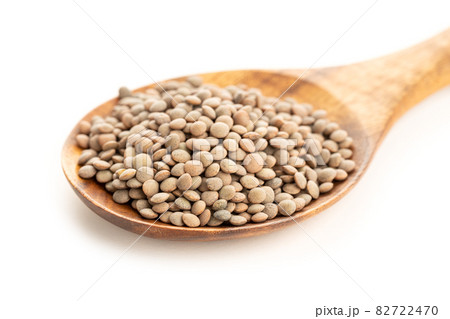 Lentil on wooden spoon on white background. Lens culinaris Lentil on wooden spoon on white background. Lens culinaris 82722470