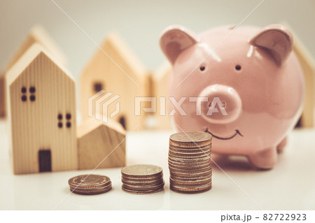Happy saving money for home concept. Piggy bank with money and home model vintage color tone. 82722923