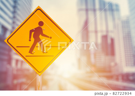Traffic crosswalk sign on blur modern city office building background. Business people walking forward concept. 82722934