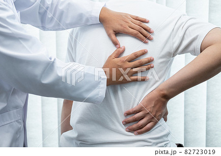 Physiotherapist working examining treating injured back of athlete male patient, Doctor doing the rehabilitation therapy pain Physiotherapist working examining treating injured back of athlete male patient, Doctor doing the rehabilitation therapy pain 82723019