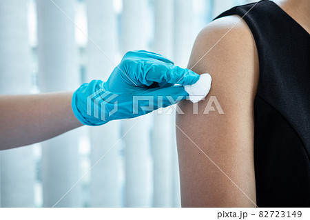 Doctor making a vaccination into patient with needle getting immune vaccine at arm for flu shot, coronavirus protective of epidemic 82723149