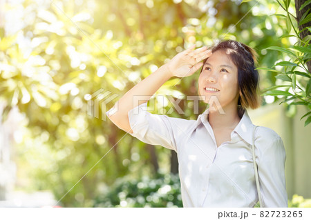 Women hand cover facial protection face skin damage from high UV sunlight outdoor. 82723265