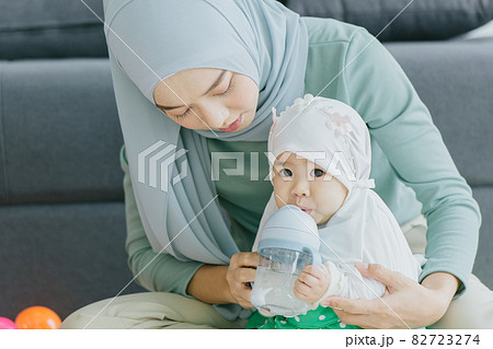 Muslim Mother look take care baby happy smiling with infant at home together cute lovely childhood indoor. Muslim Mother look take care baby happy smiling with infant at home together cute lovely childhood indoor. 82723274