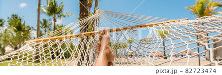 Caribbean beach selfie girl relaxing on hammock panoramic banner travel background panorama. Summer travel vacation holidays 82723474