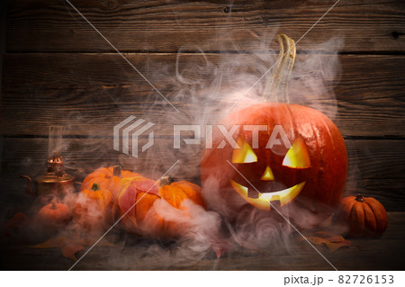 Halloween pumpkin head jack lantern on dark wooden background 82726153
