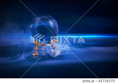 Crystal ball in a dark blue smoky background. Guessing for the future. 82726155