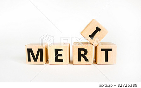 Merit symbol. The concept word 'merit' on wooden cubes on a beautiful white table. White background. Business and merit concept. 82726389