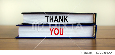 Books with the text 'thank you' on beautiful wooden table, white background. Business concept. Books with the text 'thank you' on beautiful wooden table, white background. Business concept. 82726422